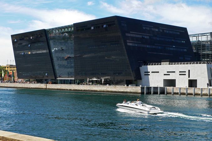 black huge building in front of water